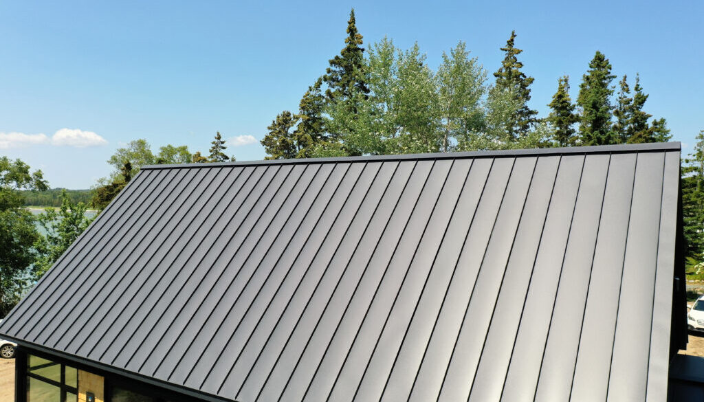 tanding seam metal roof panel showing oil canning waviness in sunlight