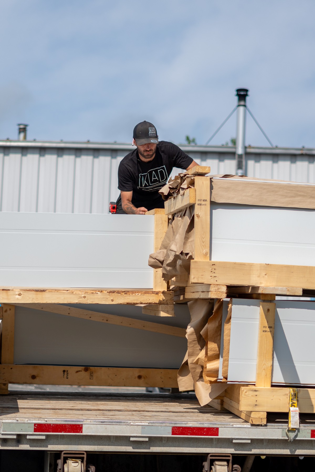 KLAD Building Armour crew loading standing seam metal roofing panels for delivery in Liverpool, Nova Scotia